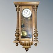 An early 20th century Junghans 8-day wall clock with pendulum and key