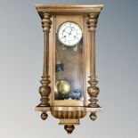 An early 20th century Junghans 8-day wall clock with pendulum and key