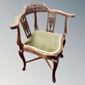 A carved Edwardian corner chair