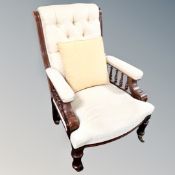 A Victorian mahogany armchair in cream buttoned fabric
