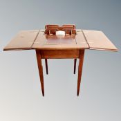 A Victorian mahogany fold out writing table