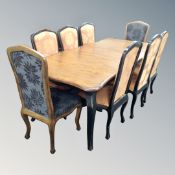 A French style two-tone shaped dining table with two extension leaves,