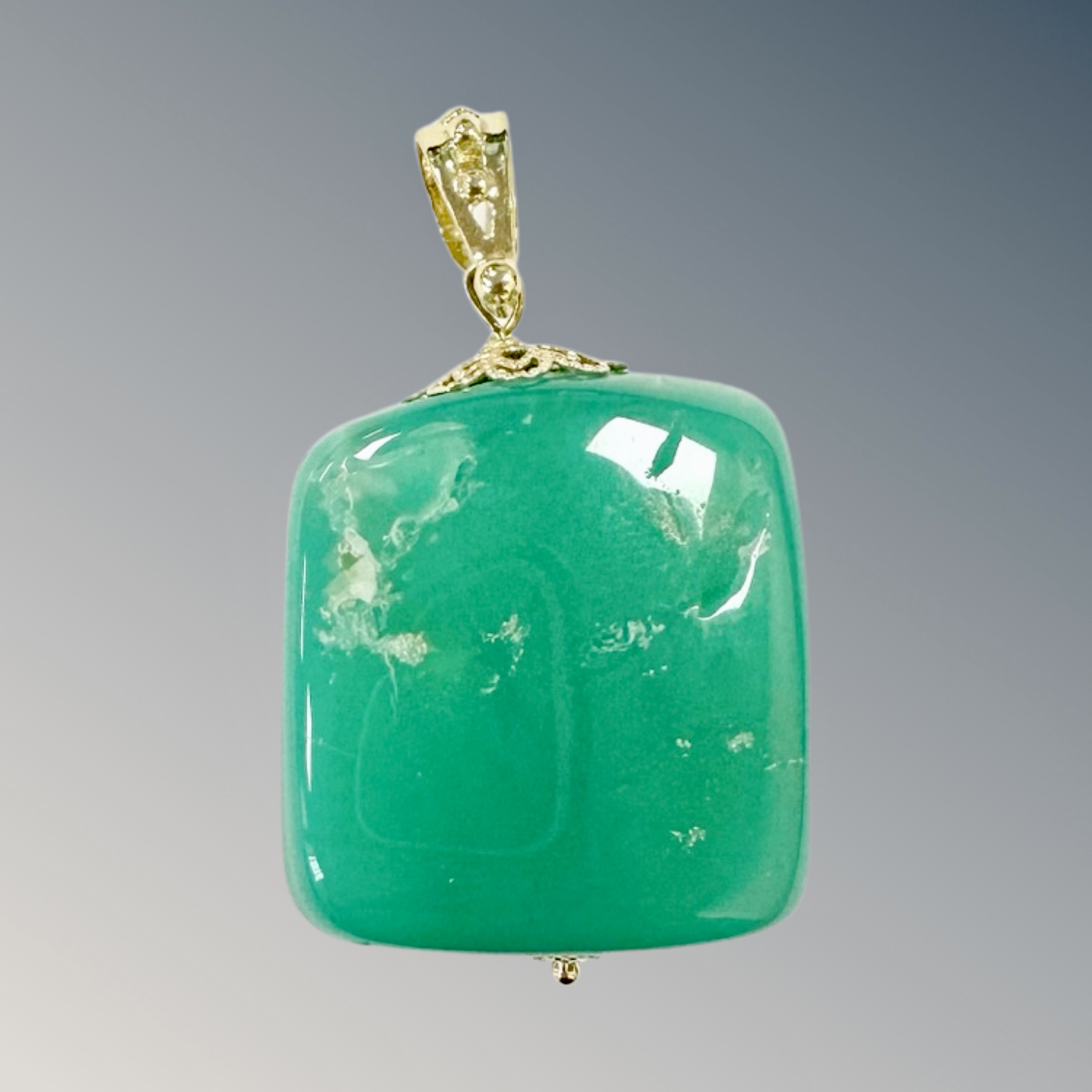 A chrysoprase pendant with 18ct yellow gold mount, length 43mm.