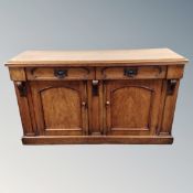 A Victorian walnut double door sideboard fitted with two drawers