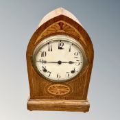 An Edwardian inlaid oak mantel clock with pendulum