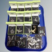 A tray of costume pendants on chains, earrings including Pentagram, Witches on broom sticks,