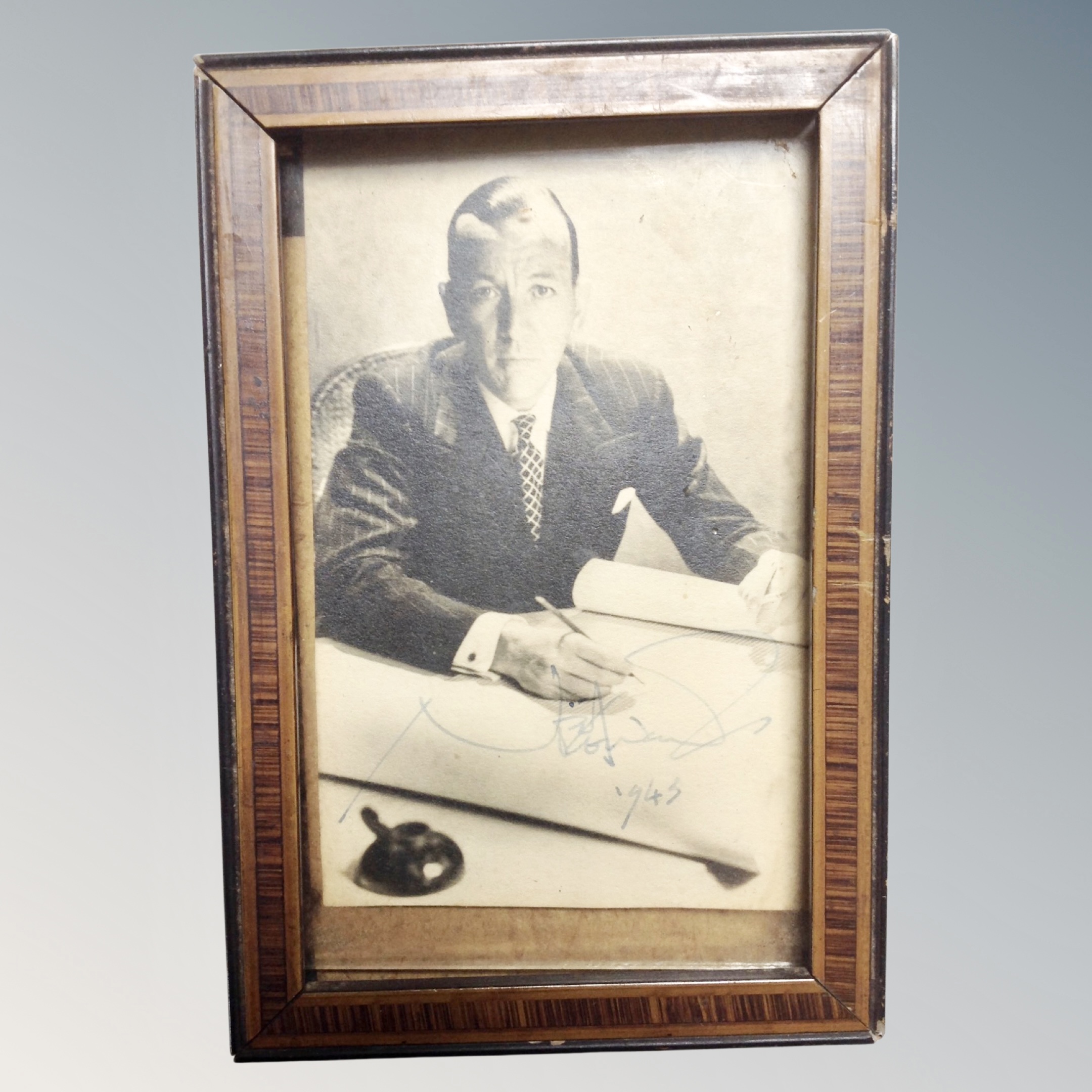 A monochrome signed photograph of Noël Coward, dated 1943.