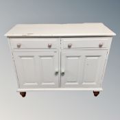 A painted pine double door cupboard fitted with two drawers