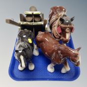 A tray of three ceramic shire horses, one with cart.