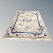 A Chinese embossed fringed carpet on golden ground,