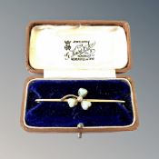 A 15ct gold brooch set with three heart shaped opals and central pearl