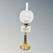 A Victorian brass column oil lamp with glass reservoir,