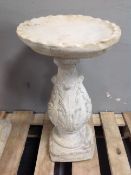 A concrete bird bath