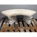 A concrete shaped garden bench on classical pedestals