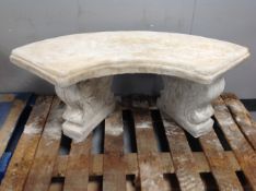 A concrete shaped garden bench on classical pedestals