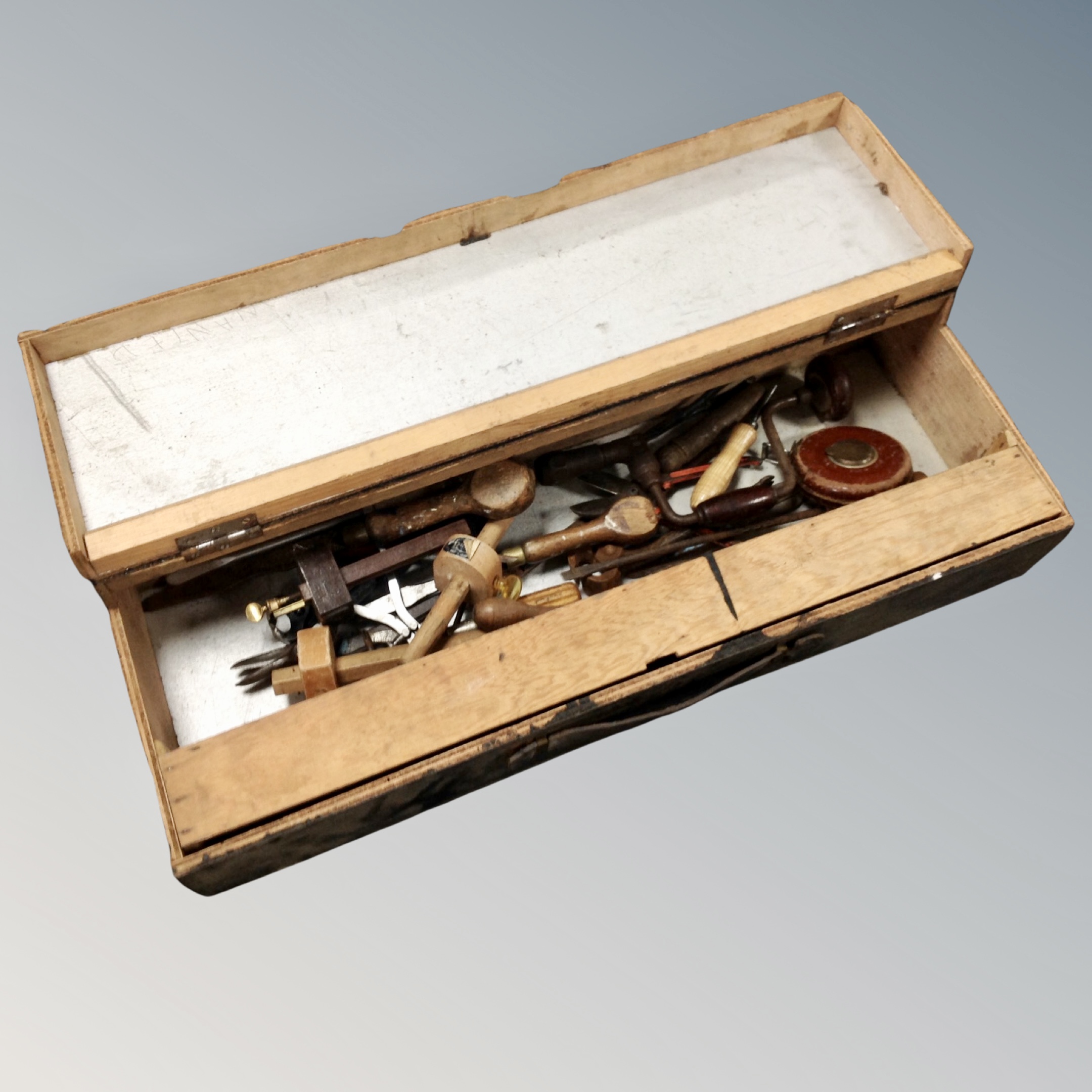 A joiner's tool box containing hand tools,