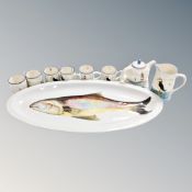 A large oval ceramic fish plate together with nine pieces of National Trust hand painted tea ware