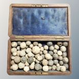 An antique oak box containing lead shot