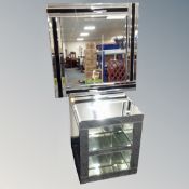 An all glass mirrored side table fitted a shelf together with a two-tone mirrored glass wall mirror