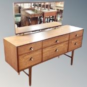 A 20th century Meredew six drawer dressing chest on raised legs together with matching five drawer