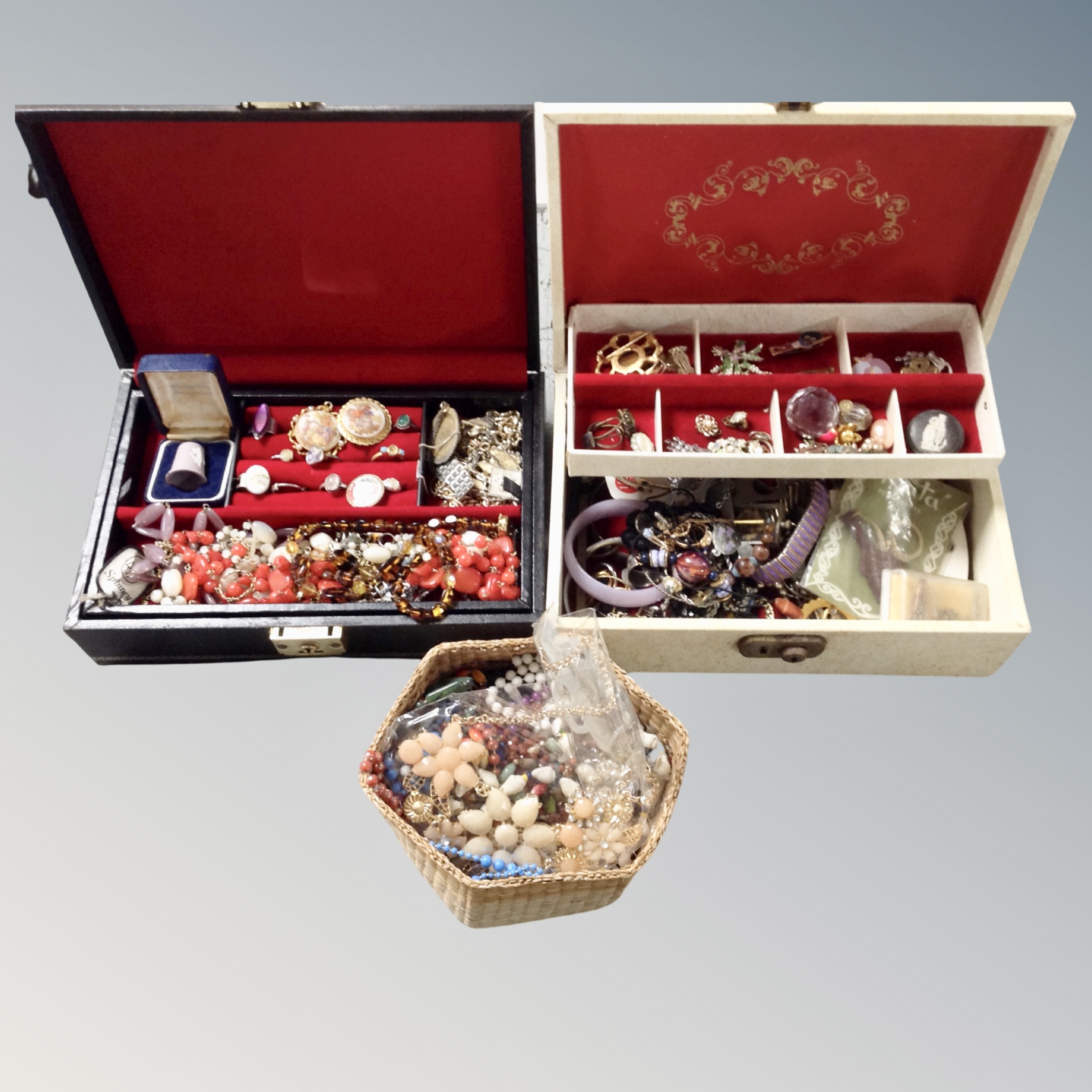 A tray of two 20th century faux leather jewellery boxes, costume jewellery, enamelled badges,