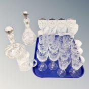 Two crystal decanters together with a crystal tankard and tray of glasses