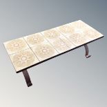 A 1970's tiled refectory coffee table on wrought metal base