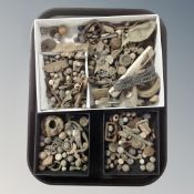 A tray of excavated metal detector finds, lead shot, pen knives,