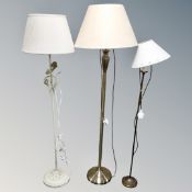 Three contemporary metal floor lamps with shades