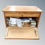 A 20th century oak sewing cabinet on castors containing accessories together with three further