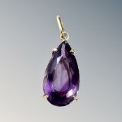 A large amethyst pendant mounted in gold