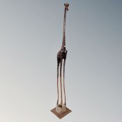 A tall wooden figure of a giraffe,