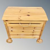 A pine dome topped toy box on wheels