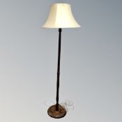A beech wood standard lamp with shade