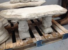 A concrete garden bench on squirrel pedestals