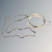 A silver engraved bangle together with a silver belcher chain, length 62 cm.