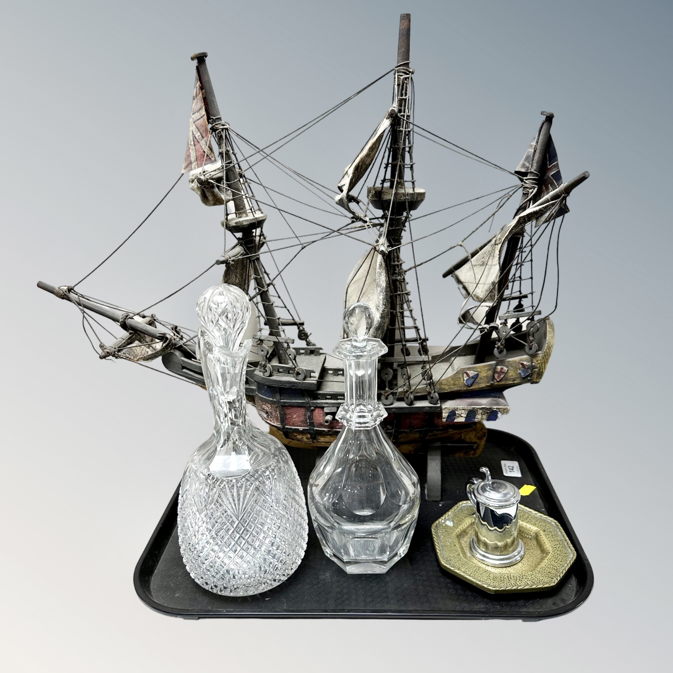 A tray of wooden galleon model, antique glass decanters,