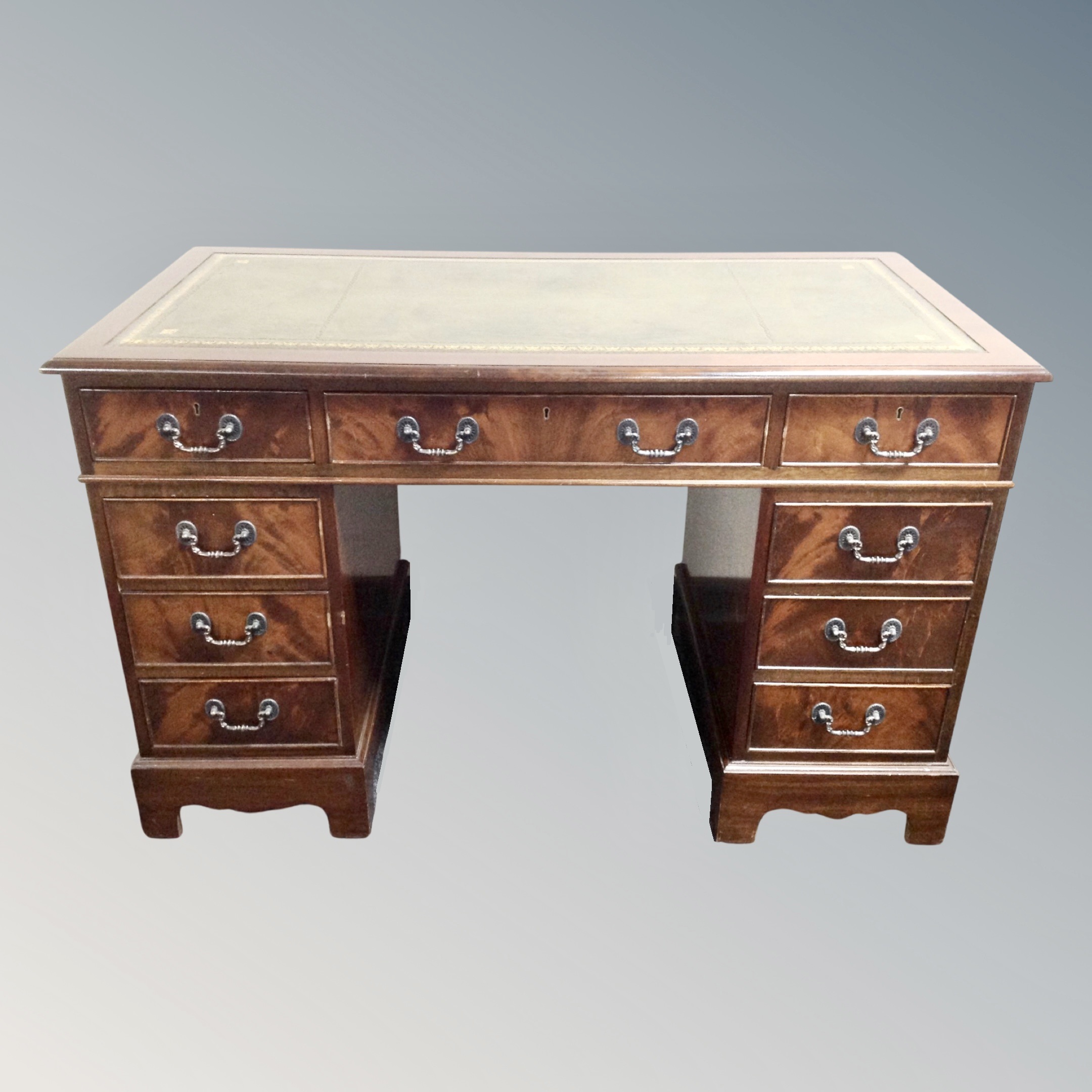 A Victorian style twin pedestal desk fitted with nine drawers with green leather inset panel,