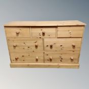 A contemporary pine seven drawer block chest