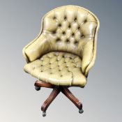 A Wade Chesterfield buttoned desk chair in olive leather