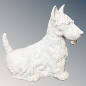 A ceramic figure of a white Scottie dog,