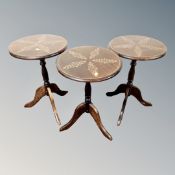 A set of three Victorian style pedestal wine tables