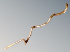 A country folk art walking stick of gnarled root