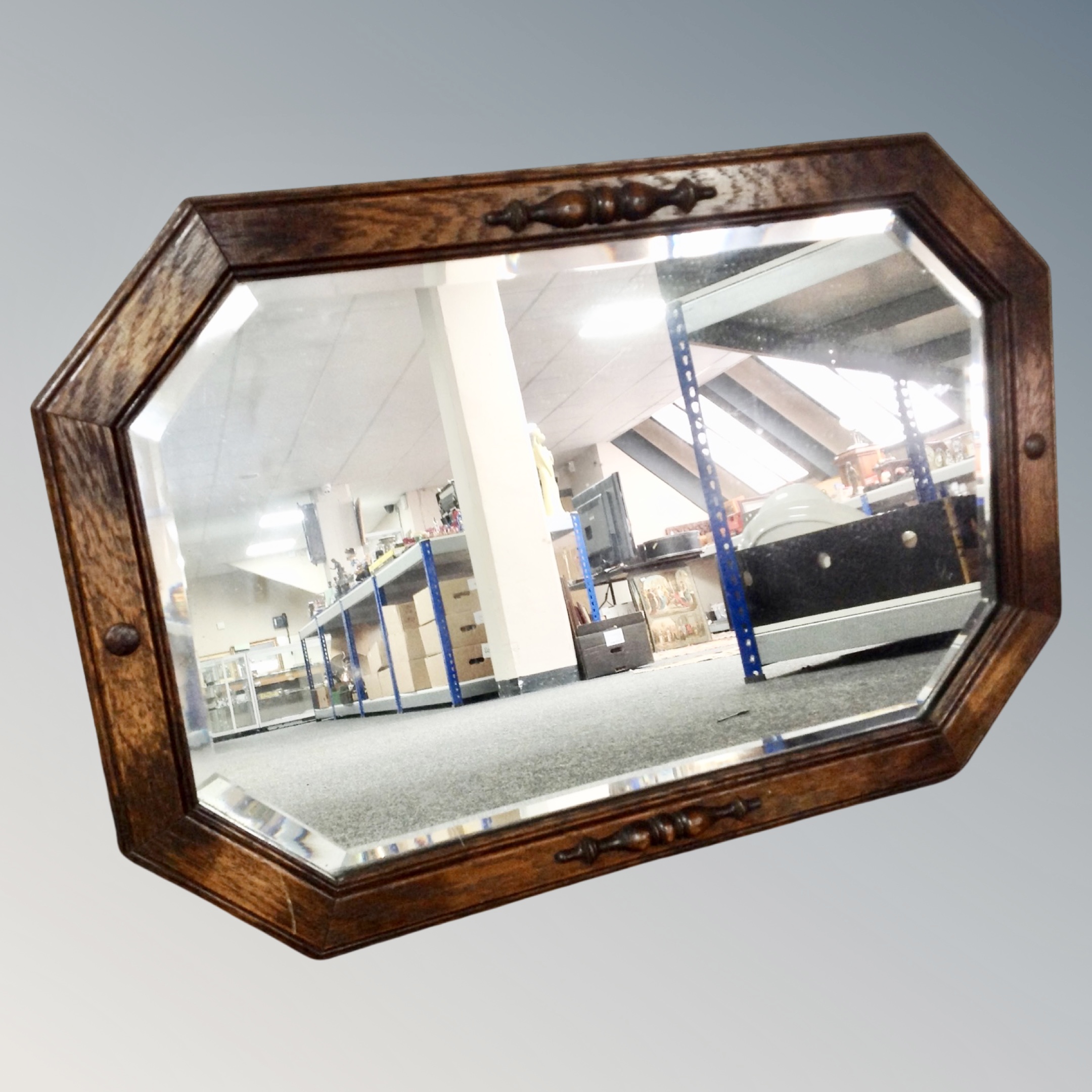 An Edwardian oak framed octagonal mirror