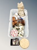 A crate of various items, hand drum, cast iron door stop,