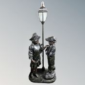 A contemporary figural floor lamp modelled as a boy and girl, height 172 cm.