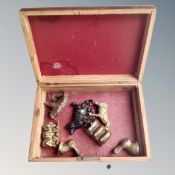 A wooden table box containing assorted brass and bronze animal figures