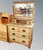 An Edwardian oak four drawer dressing chest