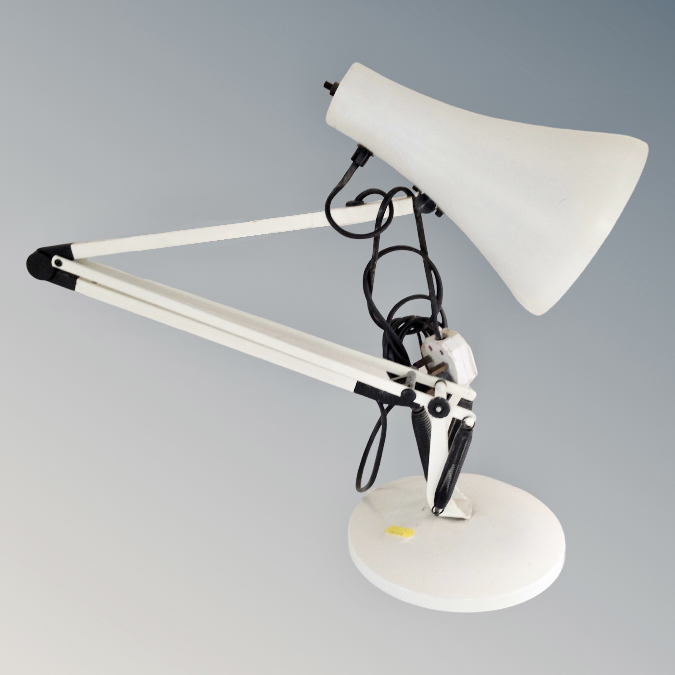 A metal angle poise table lamp