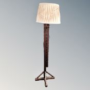 A rustic pine extending floor lamp with shade